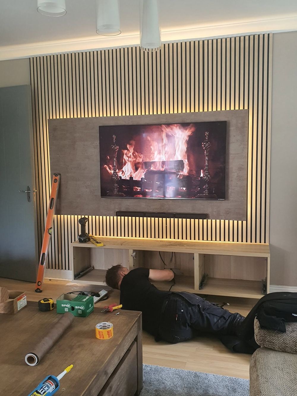 Mr Fixter fitting a TV unit on site